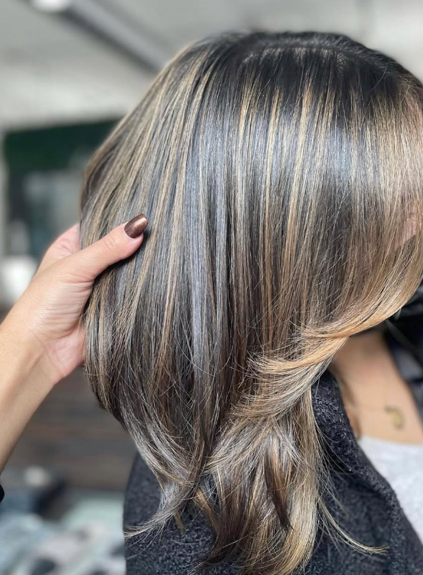 Dimensional brunette layers with cool blonde ribbons
